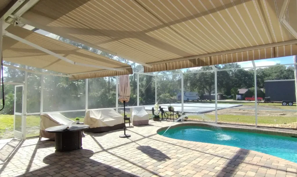 Two retractable awnings shading a screened pool patio